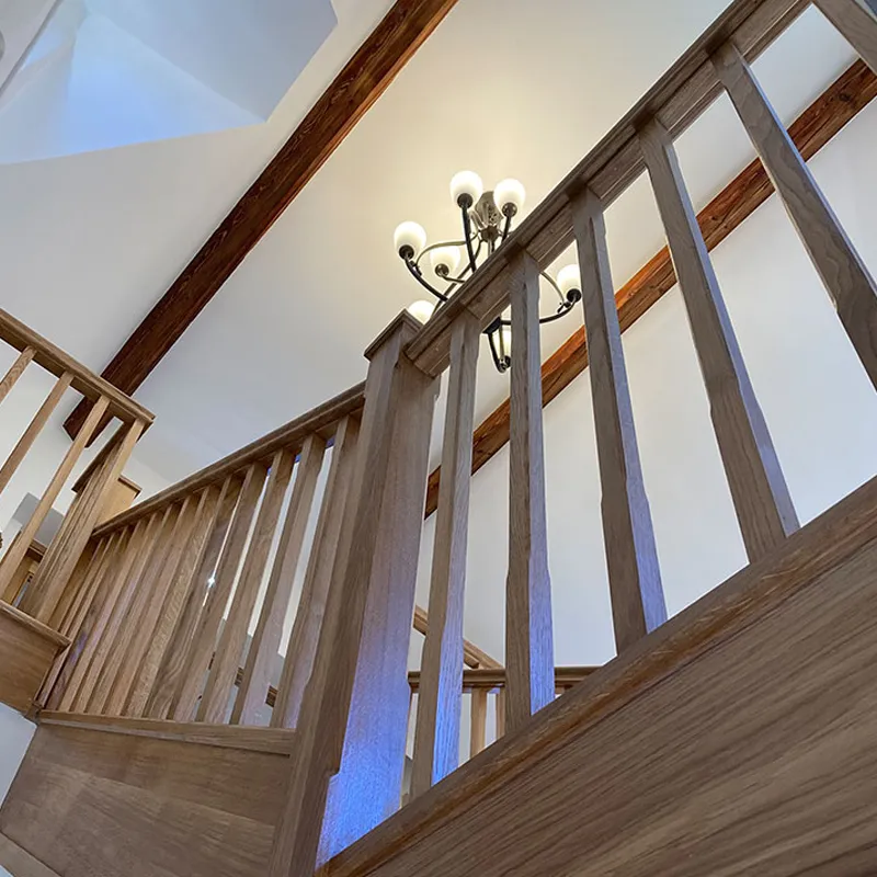 Staircase inside the Bampton Arhcive building with chandelier lighting the scene